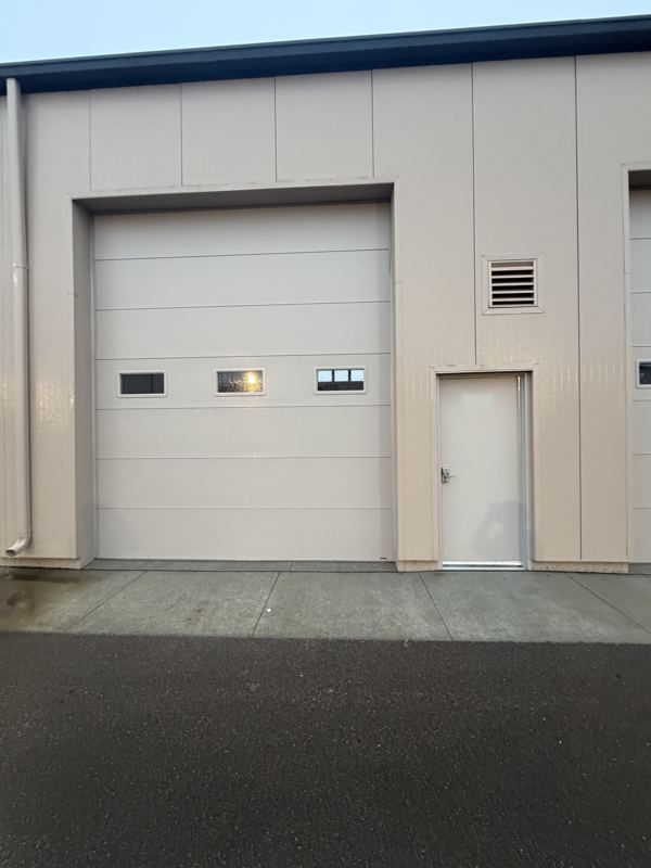 Unit exterior with overhead and service doors