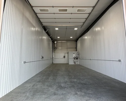 Interior of a garage condo unit with in-floor heating and automatic garage door